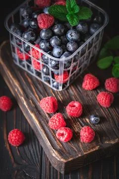 Raspberry. Raspberries in a Cup on a dark background. Summer and healthy food Stock Photos