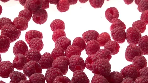 Raspberry. Raspberries falls and rolls on a white background. Video stock 77689708
