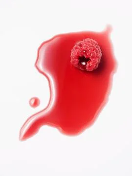 A raspberry in raspberry juice Stock Photos