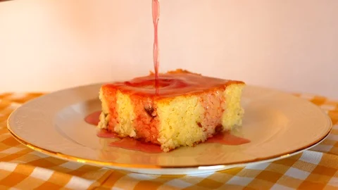 Raspberry Sauce being poured over Baked rice pudding Stock Footage 109442374