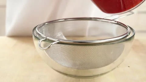 Raspberry sauce being sieved Stock Footage 24650847