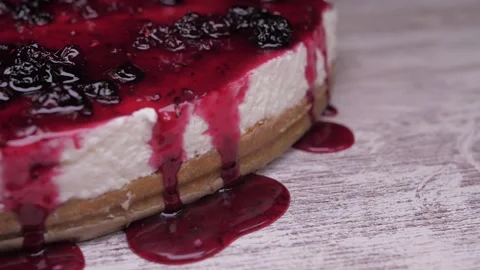 Raspberry sauce on top of berry pie slow motion Stock Footage 150457541