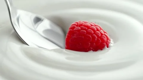 Raspberry Scooped with Silver Spoon from Creamy Thick Yogurt in Macro Stock Footage 274354640