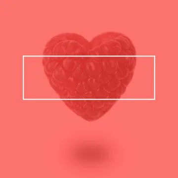 Raspberry in the shape of a heart on a coral background Stock Photos