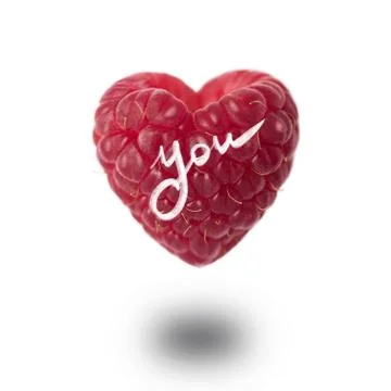 Raspberry in the shape of a heart on a white background Stockfoto's
