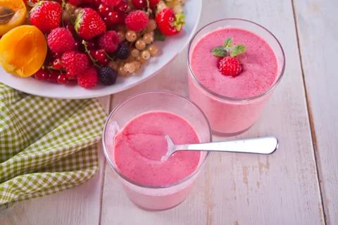 Raspberry smothies and raspberry fruit on the white background Stock Photos