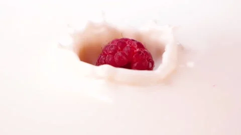 Raspberry splashing in to the milk. Healthy raspberry with yoghurt or milk Stock Footage 137936206
