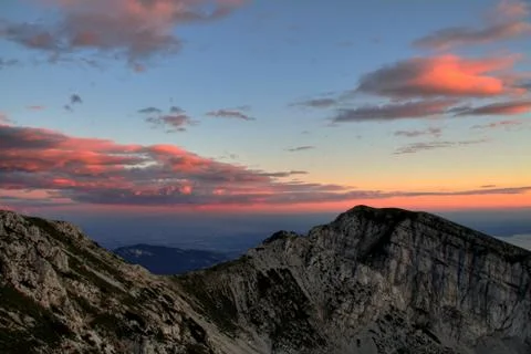 Raspberry sunset over a mountain slope Stock Photos