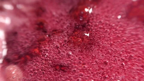 Raspberry syrup. Pink background with bubbling bubbles and raspberries. Stock Footage 136545448