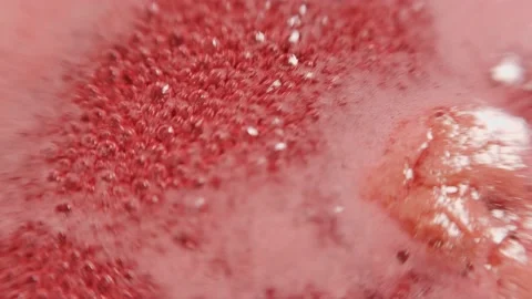 Raspberry syrup. Pink background with bubbling bubbles and raspberries. Stock Footage 141544410