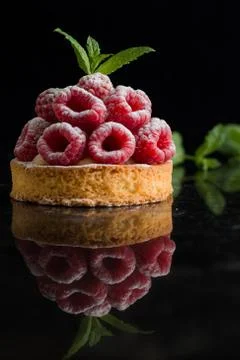 Raspberry tart dessert on dark background. Traditional french sweet pastry Stock Photos
