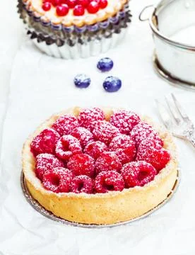 Raspberry tart dusted with sugar Stock Photos