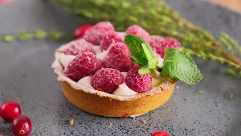 Raspberry tartlet with custard cream with mint leaf and berries slowly rotating Stock Footage 228587134