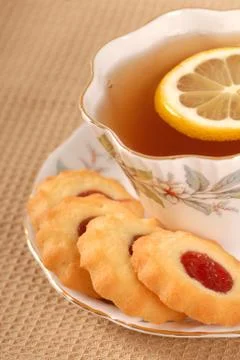 Raspberry thumbprint cookies with tea Stock Photos