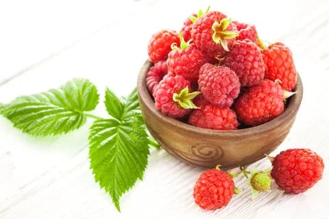 Raspberry on a white wooden table Stock Photos