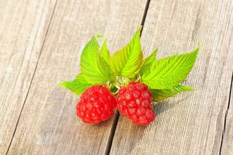 Raspberry on wooden table Raspberry with leafs on wooden table Copyright: ... Foto stock