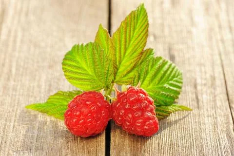 Raspberry on wooden table Raspberry with leafs on wooden table Copyright: ... Foto stock