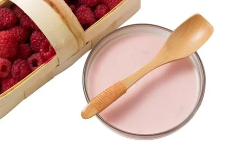 Raspberry yogurt in a glass cup with raspberry basket on a white background Stock Photos