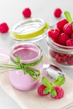 Raspberry yogurt with ripe raspberries Stock Photos