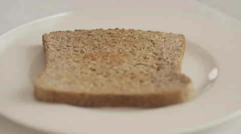 Rasperry jam spread on toasted bread 1 Stock Footage 50616141