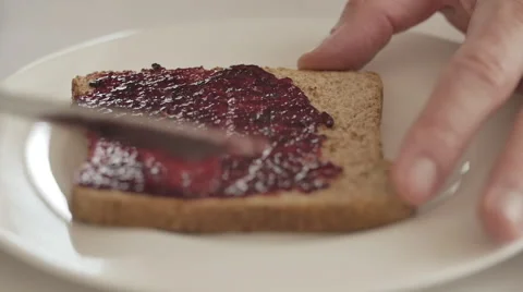 Rasperry jam  on toasted bread Stock Footage 50615777