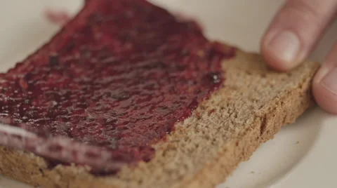 Rasperry jam  on toasted bread Stock Footage 50618666