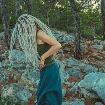 Rasta girl with dreadlocks resting on the Mediterranean coast Stock Photos