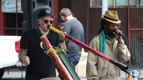 Rastafari guy intstrument Didgeridoo concert session market enjoy Stock Footage
