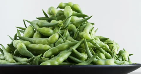 Rat tail radish close-up view. Green vegetable pile. Table spin. Stock Footage 277505919