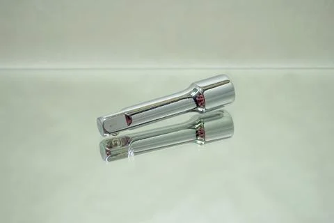 Ratchet socket wrench coupling extension on mirror Stock Photos