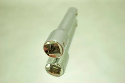 Ratchet socket wrench coupling extension on mirror Stock Photos