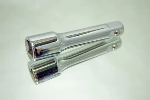 Ratchet socket wrench coupling extension on mirror Stock Photos