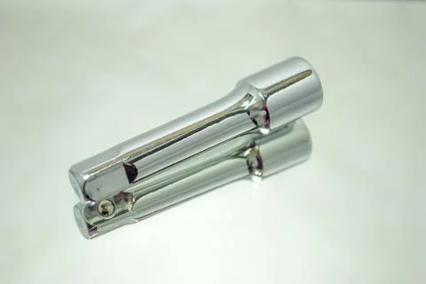Ratchet socket wrench coupling extension on mirror Stock Photos