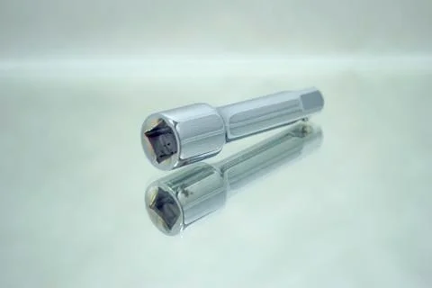 Ratchet socket wrench coupling extension on mirror Stock Photos