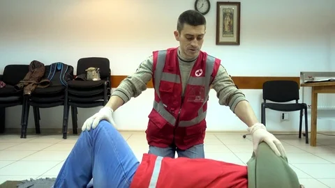 Rates of first aid from the Red Cross - chest compressions Stock Footage 70563353