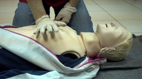 Rates of first aid from the Red Cross - chest compressions On A Mannequin Video stock 70563446