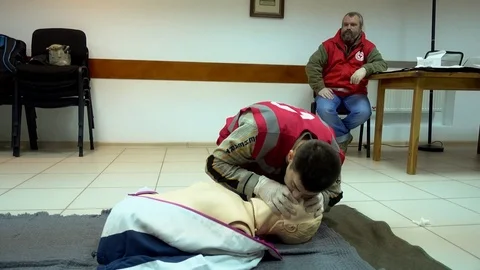 Rates of first aid from the Red Cross - chest compressions On A Mannequin Stock Footage 70563588