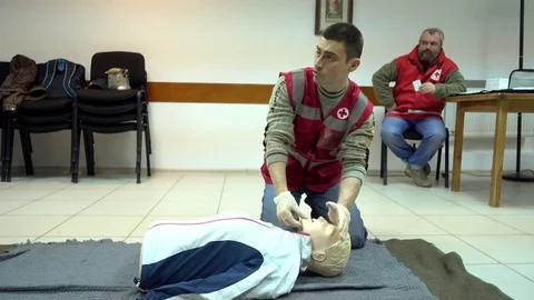 Rates of first aid from the Red Cross - chest compressions On A Mannequin Stock Footage 70563638
