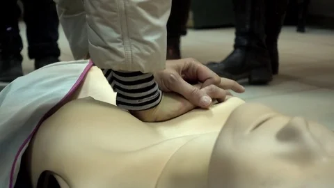 Rates of first aid from the Red Cross - chest compressions On A Mannequin Stock Footage 70563790