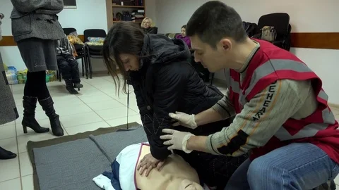 Rates of first aid from the Red Cross - chest compressions On A Mannequin Stock Footage 70563791