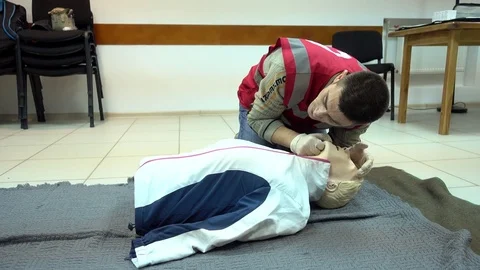 Rates of first aid from the Red Cross - chest compressions On A Mannequin Stock Footage 70563793