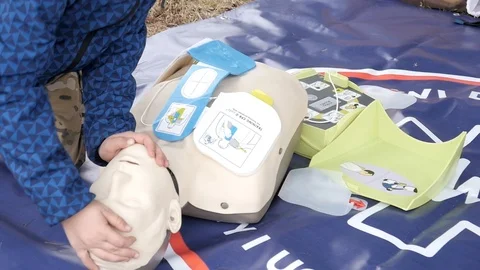 Rates of first aid from the Red Cross - breathing to a Mouth On A Mannequin Stock Footage 97057515