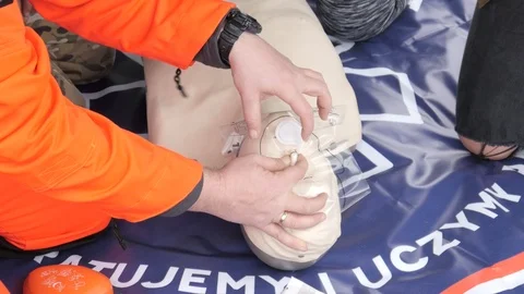 Rates of first aid from the Red Cross - breathing to a Mouth On A Mannequin Stock Footage 97057762