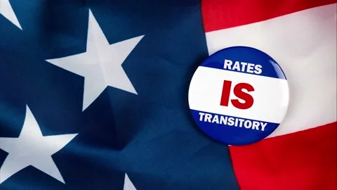 Rates is transitory text quote on election button laying on the star spangled Video stock 170629700