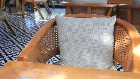 Rattan chair with pillow in cafe with patterned floor. Stock Footage 333152103