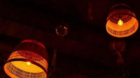 Rattan lamps in the dark setting of a restaurant Stock Footage 334339970