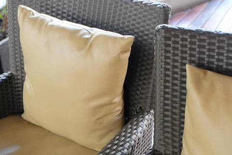 Rattan Sofa with Brown Leather Cushion Stock Photos