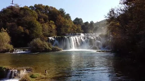 Raven Chilling at the Waterfall Stock Footage 167802561
