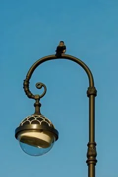 Raven on a lamppost. Stock Photos