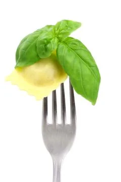 Ravioli an basil on fork Stock Photos